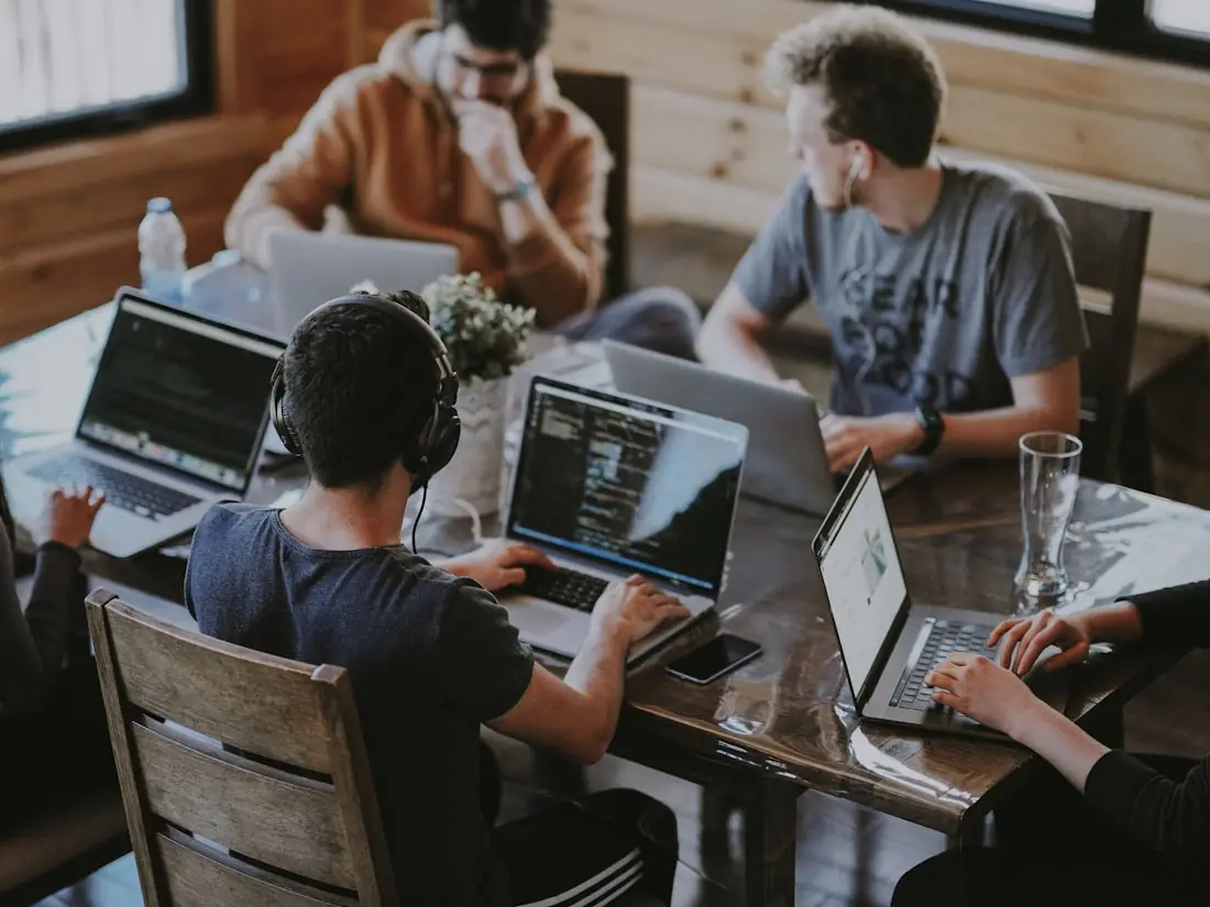 A diverse Spotto Finance team collaborating around a table in a bright, modern office