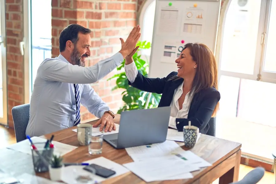 A friendly consultation between a broker and a client at a desk